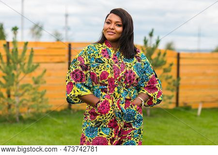 Portrait Of Beautiful African American Woman Having Fun On Village Or Suburbian. Outdoor Portrait Of