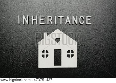 Word Inheritance Made With White Letters And House Model On Black Background, Flat Lay