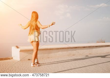 Woman Summer Dance. Silhouette Of A Happy Woman Who Dances, Spins And Raises Her Hands To The Sky. A