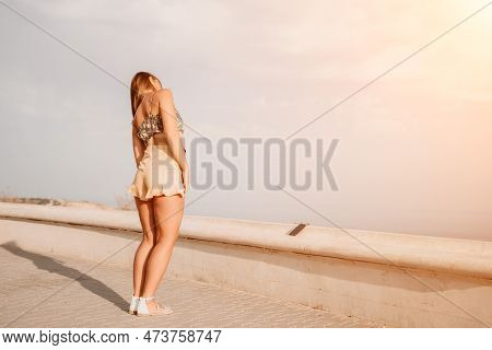 Woman Summer Dance. Silhouette Of A Happy Woman Who Dances, Spins And Raises Her Hands To The Sky. A