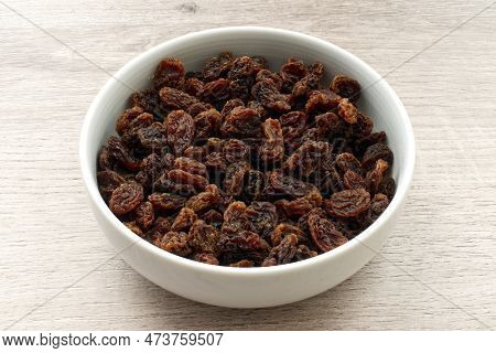 Dried Fruit Sultana Raisins In A Bowl On Wooden Background.