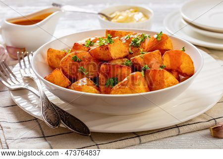 Patatas Bravas, Deep Fried Potatoes With Spicy Sauce In White Bowl On White Wood Table, Spanish Cuis