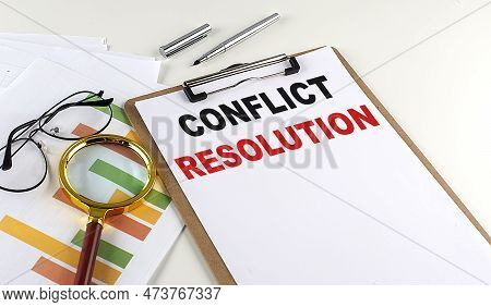 Conflict Resolution Text On A Clipboard With Chart On White Background, Business Concept