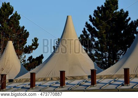 White Tarpaulin Taut, Shading From The Sun And Rain Over The Terrace Of The Restaurant, On The Playg