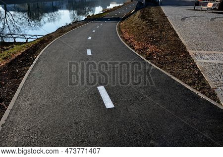 Embankment With A New Bike Path Right Next To The Meanders Of The River. It Copies Its Flow And Enco