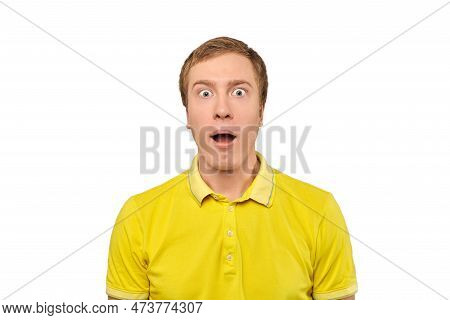 Surprised Young Man With Funny Facial Expression In Yellow T-shirt, White Isolated Background. Shock