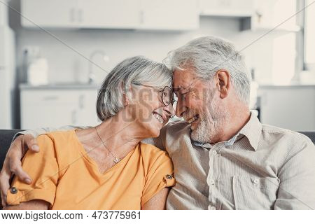 Happy Laughing Older Married Couple Talking, Laughing, Standing In Home Interior Together, Hugging W