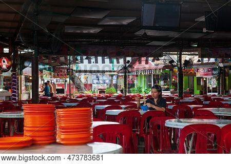 Georgetown, Penang, Malaysia - September 02, 2014: Young Woman Eating Noodle At Food Market In Histo