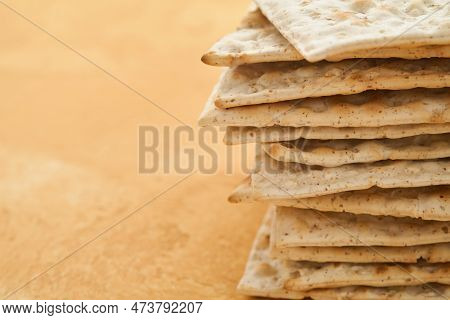 Matzah Passover Celebration Concept. Traditional Ritual Jewish Bread On Sand Color Old Wall Backgrou
