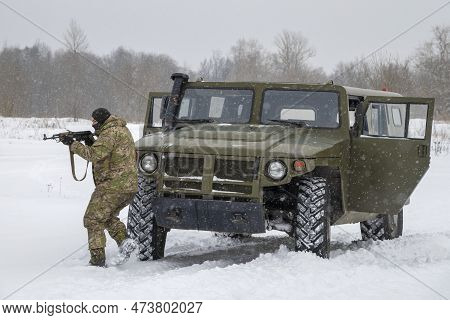 Krasnoye Selo, Russia - February 19, 2023: A Camouflage Fighter With A Kalashnikov Assault Rifle Tak