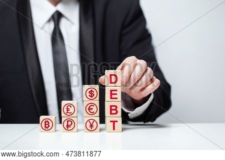 Wooden Blocks With Word Debt Currency Icons: Us Dollar, Euro, Ruble, Yuan, Pound Sterling, Bitcoin, 