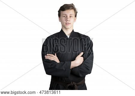 Taekwando.a Teenager In A Black Kimano Who Is Engaged In Taekwando.