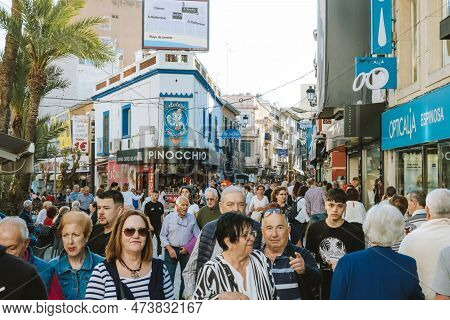 Benidorm, Spain - 01 April, 2023: People Walking And Enjoy Sunny Day On The Shopping Street In Benid