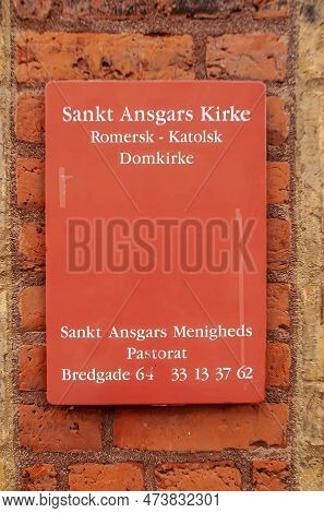Copenhagen, Denmark - September 13, 2010: White On Red Metal Plate On Church Brick Wall Of Sankt Ang