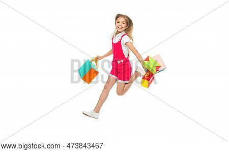 Smiling Teen Girl Jumping After Shopping Isolated On White. Teen Girl Jumping After Shopping