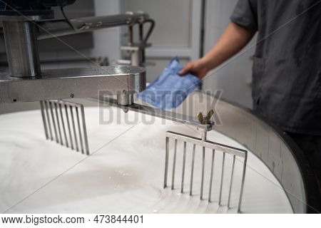 Cheesemaker Pours Rennet Starter Ferment In A Large Steel Tank Full Of Milk. Cheese Production Chees