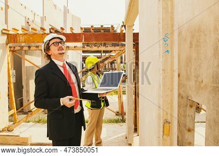 Architect Caucasian Housing Estate Inspect Prefab House Wall In Factory Warehouse With Female Worker