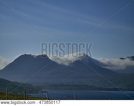 Clouds Lingering Over Mountains In The Highlands Of Scotland On A Bright Sunny Day With Clear Blue S