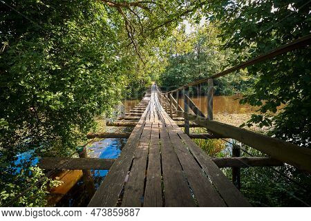 Wooden Suspension Bridge.  Pedestrian Hanging Bridge Over Naroch River Between Ruchitsa And Krasnica