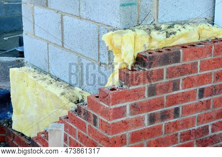 Insulating Walls Of New Build Houses By Placing Rock Wool Inside Wall Cavities As Part Of The Energy