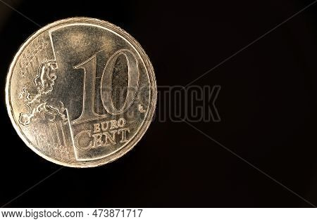 Close Up Extreme Macro Of A Ten Cent Cents Euro Coin Against Dark Black Background As Concept For Eu