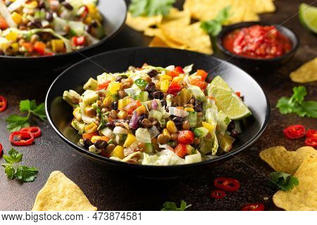 Mexican Style Salad Of Black Beans, Lentils, Corn, Tomato And Lettuce With A Salsa And Tortilla Chip