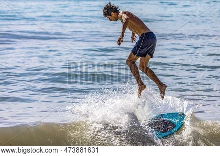 Playa Del Carmen, Mexico, April 2, 2023: Surfer Jumping Off The Surfboard When A Wave Hits Hard On H