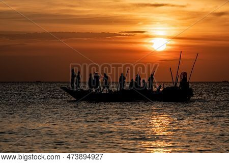 Dar Es Salaam, Tanzania - March 2023: Local Fishermen Are In The Process Of Fishing On An Old Boat.
