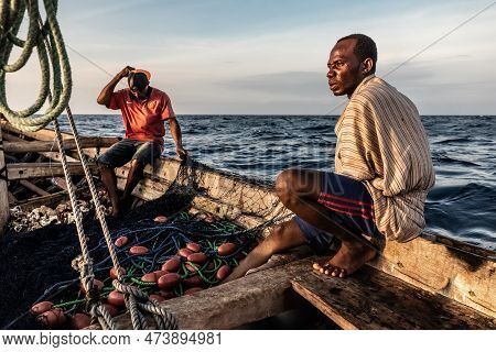 Dar Es Salaam, Tanzania - March 2023: Local Fishermen Are In The Process Of Fishing On An Old Boat.