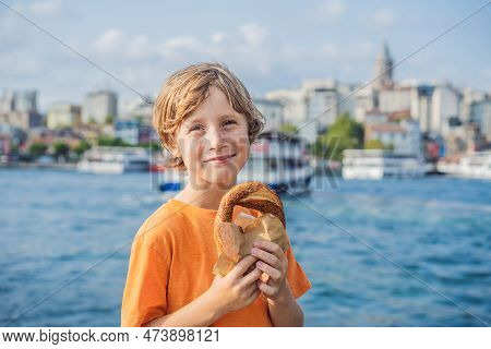 Boy In Istanbul Having Breakfast With Simit And A Glass Of Turkish Tea. Glass Of Turkish Tea And Bag