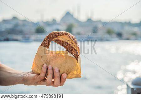 Man In Istanbul Having Breakfast With Simit And A Glass Of Turkish Tea. Glass Of Turkish Tea And Bag