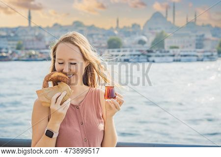 Woman In Istanbul Having Breakfast With Simit And A Glass Of Turkish Tea. Glass Of Turkish Tea And B