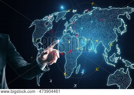 Close Up Of Businessman Hand Using Glowing Digital Map With Ariplane Connections On Dark Background.