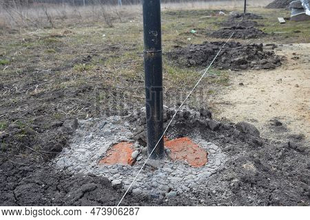 Fence Footings. Close Up On Concrete Footing Metal Building. Fence Post Installation.