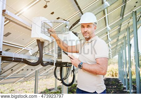 Man Adjusting Electric Switchboard According To Instuctions. Male Worker Checking If Switchers Turne