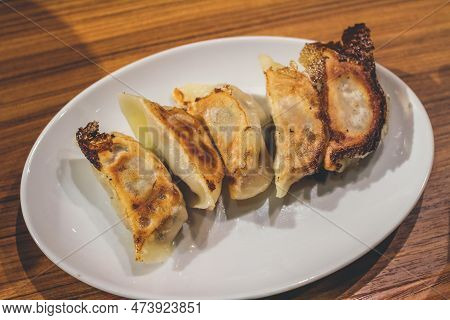 The Deep Fried Japanese Dumplings Gedza On A Wood Background