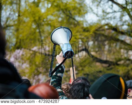 A Large Crowd Of Protesters Hold Up Signs And Banners, Shouting Their Message Of Resistance Against 