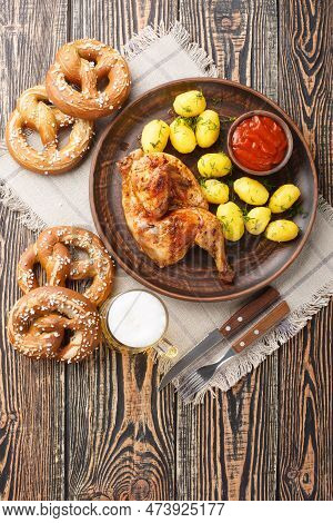 Bavarian Roast Chicken Hendl With Boiled Potatoes Served With Beer And Pretzel Closeup On The Wooden