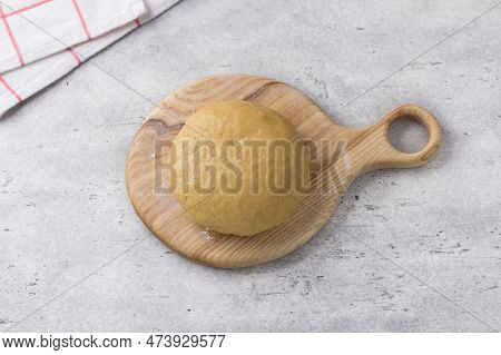 Wooden Board With Ready Dough For Koulourakya Greek Easter Cookies With Sesame Seeds On Gray Texture