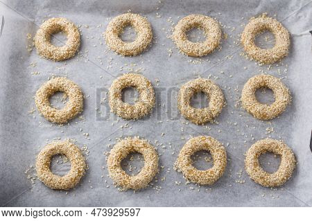 Raw Rings Of Greek Orange Sesame Cookies Koulourakya On A Parchment Baking Sheet Before Baking, Top 