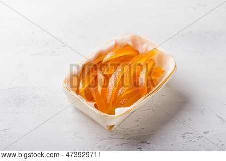 Wicker Birch Basket With Fresh Juicy Candied Oranges On A Light Gray Background