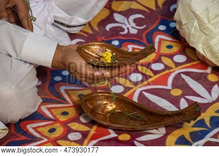 A Man Groom Holding A Metal Kosha Kushi In His Hand. A Decorated Copper Yoni Hindu Prayer Elements C