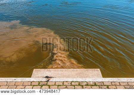 Sewage Pipe Outfall Into The River, Water Pollution And Environmental Damage Concept, Selective Focu