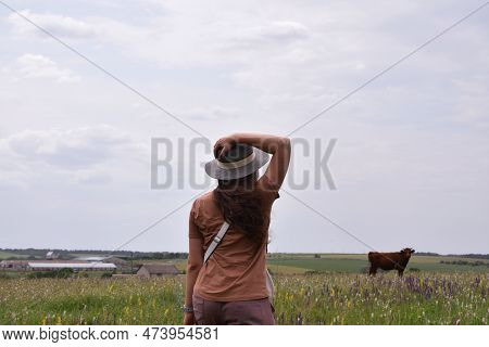 The Girl On The Farm Looks At The Bik. Field