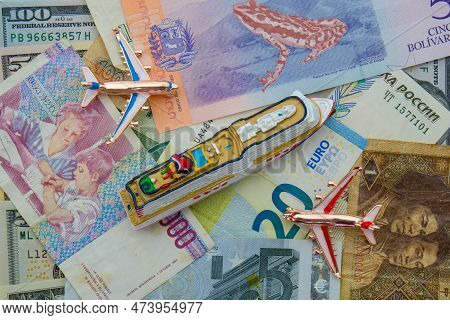 Miniature Cruise Ship, Airplanes Sitting On Arrangement Of International Currencies Including Euro, 
