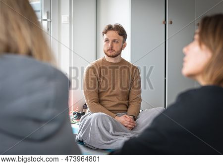 Vilnius, Lithuania - March 26 2023: Boy Sitting On A Mat With A Blanket During A Yoga Class Or Group