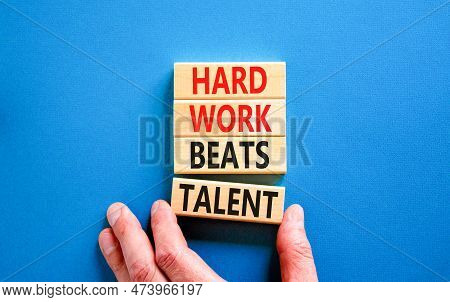 Hard Work Beats Talent Symbol. Concept Words Hard Work Beats Talent On Wooden Block. Beautiful Blue 
