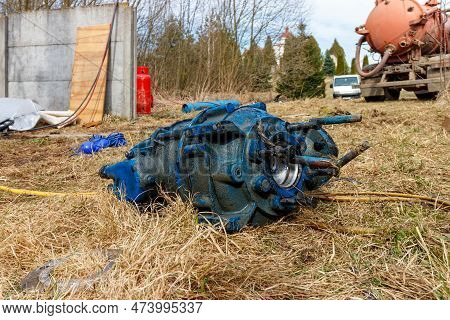 Old Faulty Pump For Pumping Feces Lying On The Grass. Replacing An Old Faulty Pump With A New One