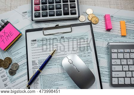 1040 Tax Forms With Pen And Computer Keyboard On Table