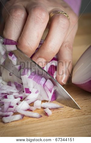 Chef Choppig A Red Onion With A Knife